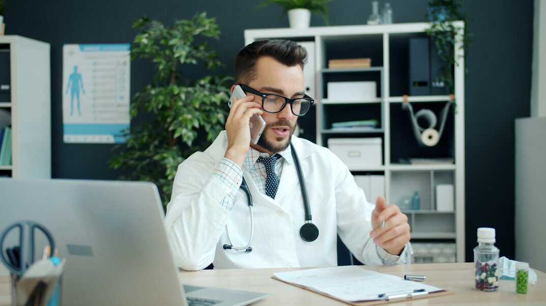 doctor smiling at desk